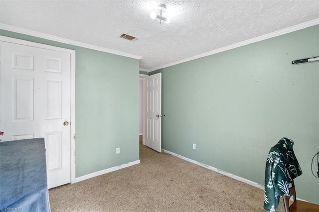 unfurnished bedroom featuring crown molding, carpet floors, and a textured ceiling