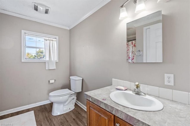 bathroom with vanity, hardwood / wood-style floors, crown molding, and toilet