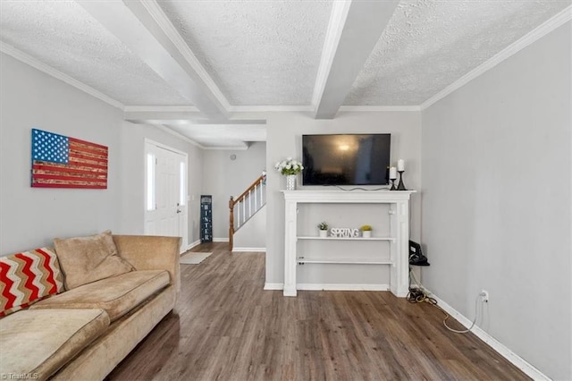 living room featuring hardwood / wood-style flooring, beamed ceiling, ornamental molding, and a textured ceiling