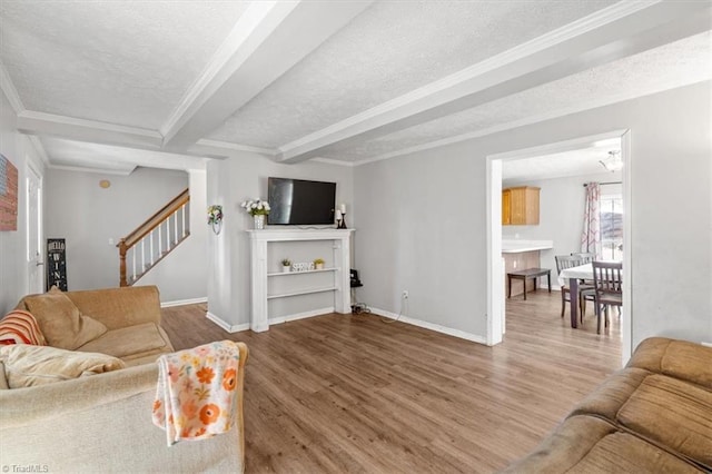 living room featuring crown molding, hardwood / wood-style floors, and a textured ceiling