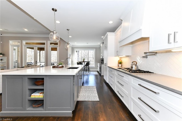 kitchen featuring gray cabinetry, white cabinets, a large island, and decorative light fixtures