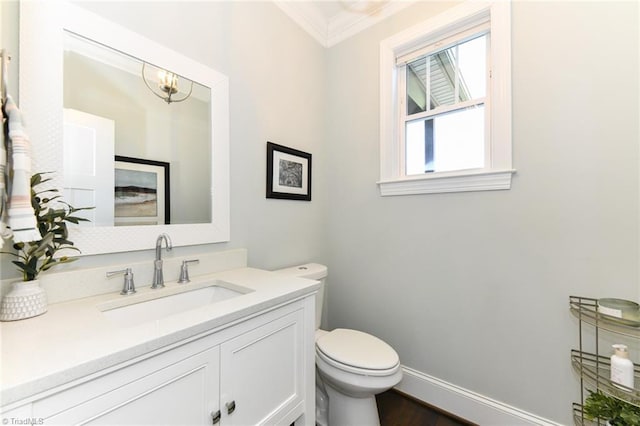 bathroom featuring hardwood / wood-style floors, toilet, vanity, and ornamental molding