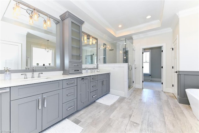 bathroom with hardwood / wood-style flooring, shower with separate bathtub, vanity, and a healthy amount of sunlight