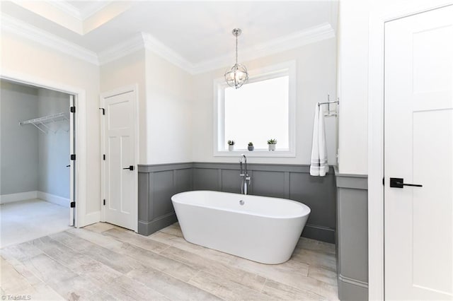 bathroom featuring a bathing tub and crown molding