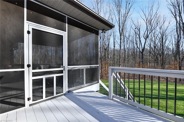 deck with a sunroom and a yard