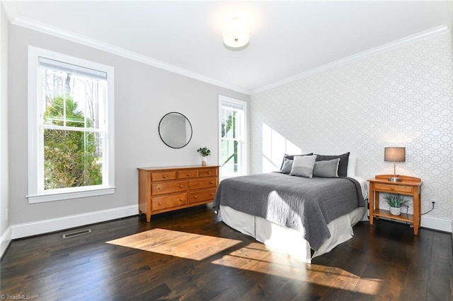 bedroom with dark wood-type flooring, crown molding, and multiple windows