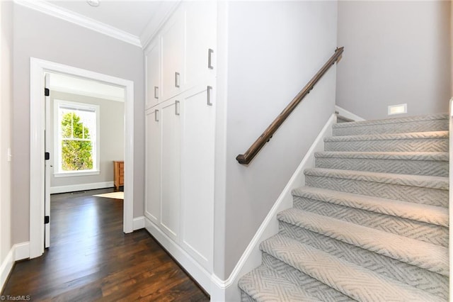 stairs featuring crown molding and hardwood / wood-style flooring