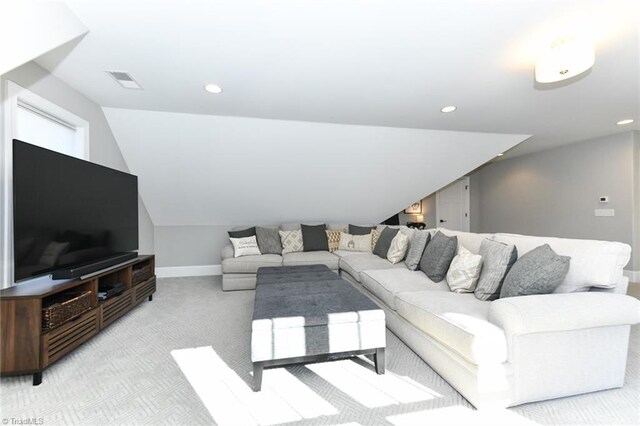 carpeted living room featuring lofted ceiling