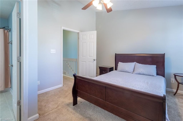 bedroom featuring ceiling fan, light carpet, and lofted ceiling