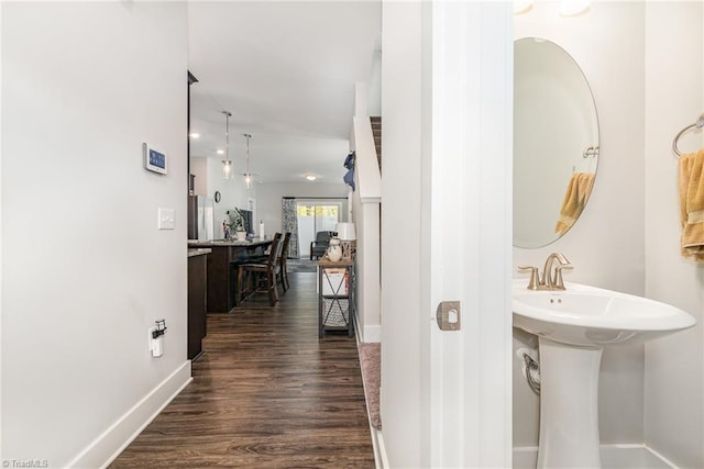 hallway featuring dark wood-type flooring and sink