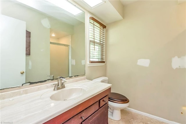 bathroom featuring walk in shower, vanity, toilet, and tile patterned flooring