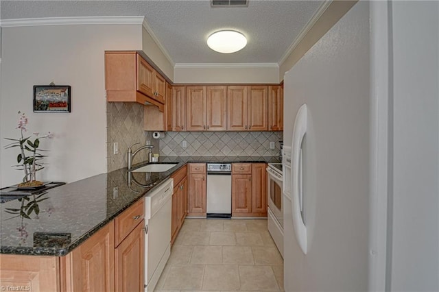 kitchen featuring white appliances, ornamental molding, sink, and dark stone counters