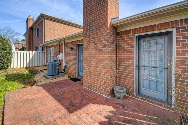 doorway to property with a patio and cooling unit