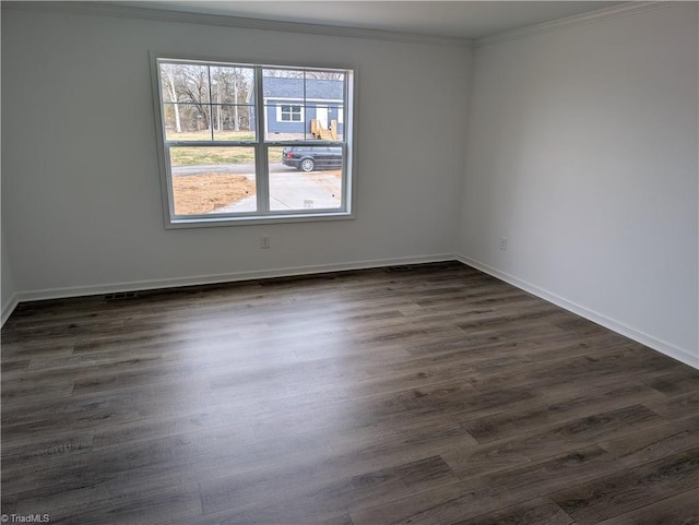 empty room with crown molding and dark wood-type flooring