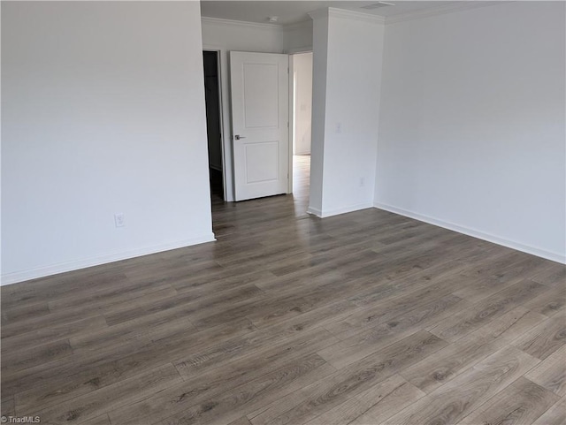 spare room with crown molding and dark hardwood / wood-style flooring