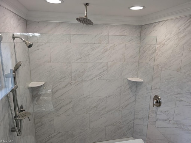 bathroom featuring a tile shower and crown molding