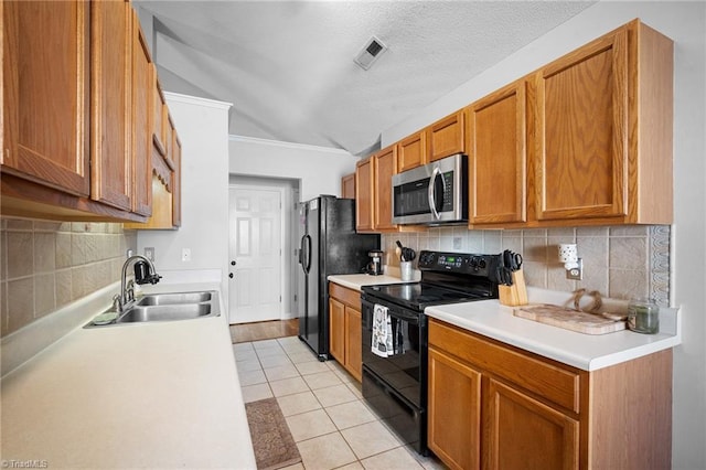 kitchen with black appliances, a sink, lofted ceiling, light countertops, and ornamental molding