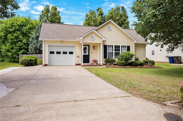 view of front of property with a garage, concrete driveway, a front yard, and a shingled roof