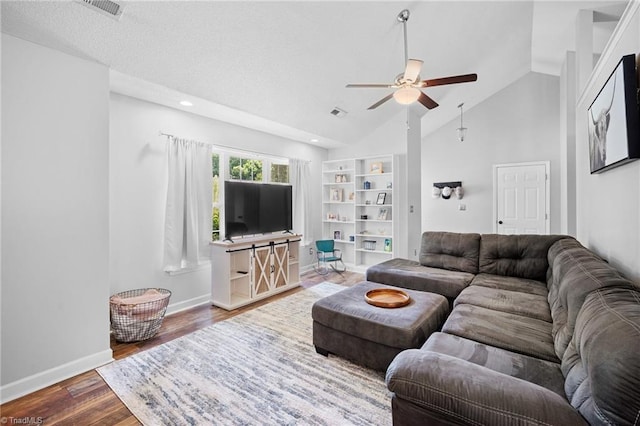 living area with a ceiling fan, lofted ceiling, wood finished floors, baseboards, and built in shelves
