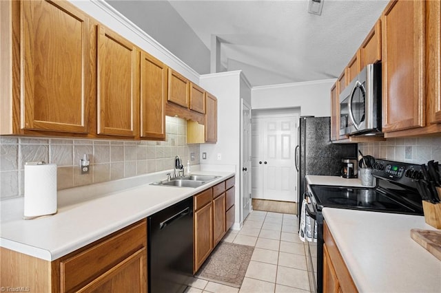 kitchen with black appliances, a sink, light tile patterned flooring, decorative backsplash, and vaulted ceiling