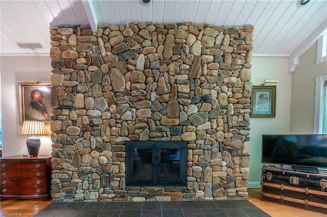 interior details featuring a stone fireplace, crown molding, hardwood / wood-style floors, and wooden ceiling