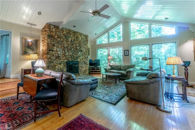 living room with a healthy amount of sunlight, light wood-type flooring, ceiling fan, and a fireplace