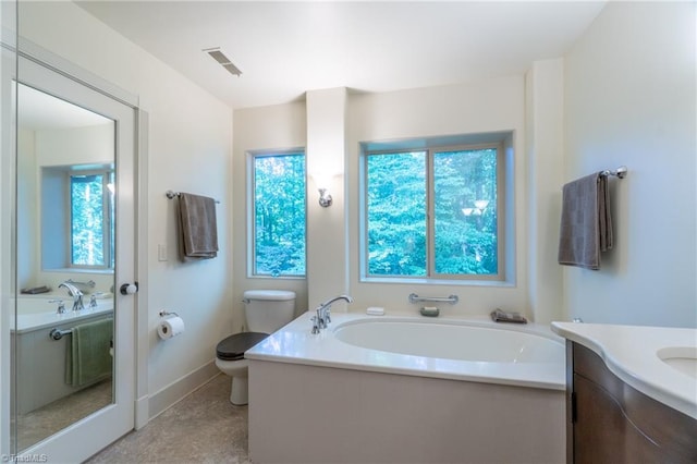 bathroom featuring a bathtub, vanity, and toilet