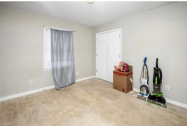 interior space featuring baseboards, a closet, and a textured ceiling