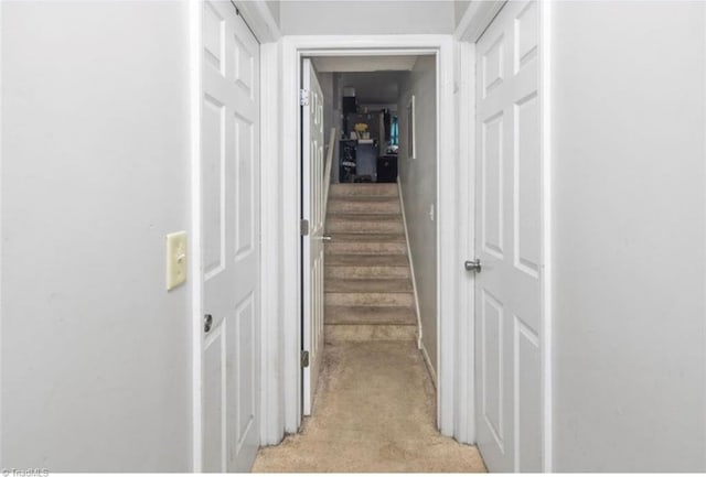 hallway featuring light carpet