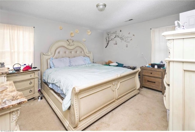 bedroom featuring light carpet and visible vents