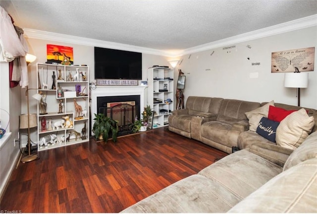 living room with a fireplace, a textured ceiling, crown molding, and wood finished floors