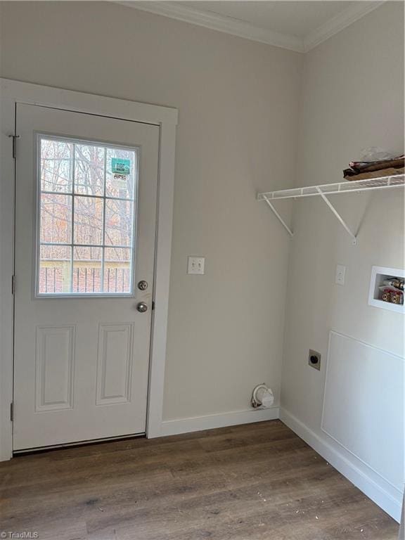 clothes washing area featuring hardwood / wood-style flooring, hookup for an electric dryer, ornamental molding, and washer hookup