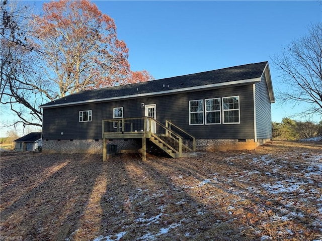 back of house with a deck