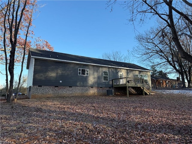 back of house featuring central AC and a deck