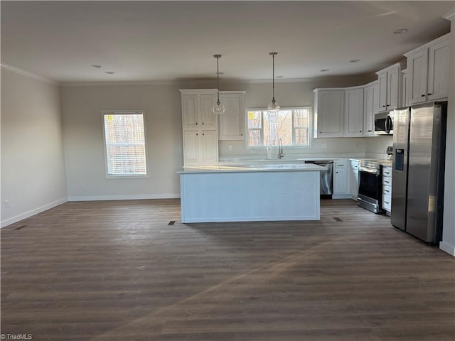 kitchen with white cabinetry, hanging light fixtures, stainless steel appliances, dark hardwood / wood-style flooring, and crown molding