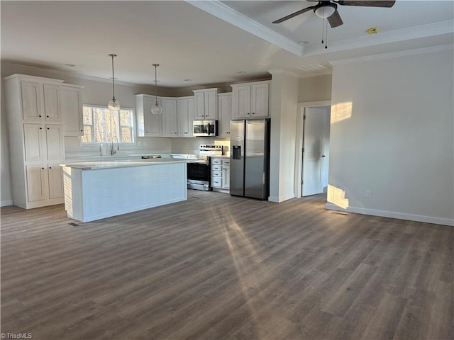 kitchen featuring sink, crown molding, dark hardwood / wood-style flooring, white cabinetry, and stainless steel appliances