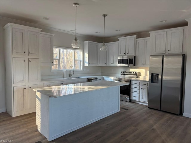 kitchen with appliances with stainless steel finishes, sink, white cabinets, dark hardwood / wood-style floors, and a kitchen island