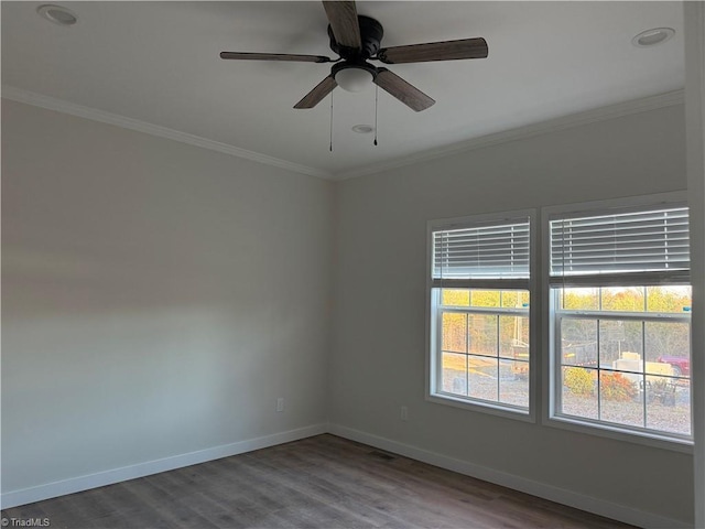 spare room featuring crown molding, ceiling fan, and wood-type flooring