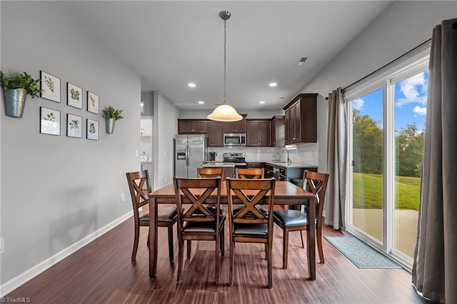 dining space with hardwood / wood-style floors and sink