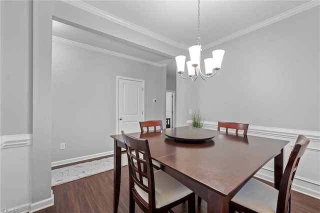 dining space with ornamental molding, a notable chandelier, and dark wood-type flooring