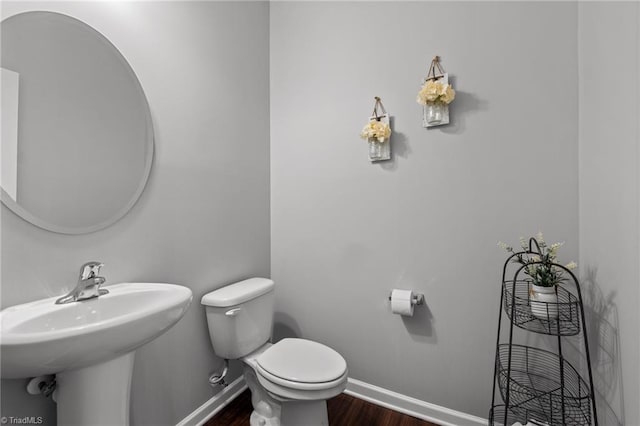 bathroom featuring hardwood / wood-style floors and toilet