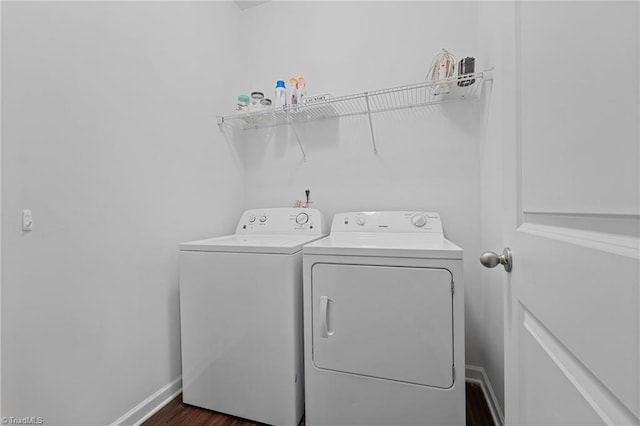 laundry area with dark wood-type flooring and independent washer and dryer