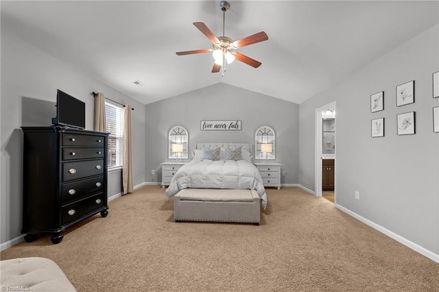 carpeted bedroom featuring lofted ceiling, ceiling fan, and ensuite bathroom