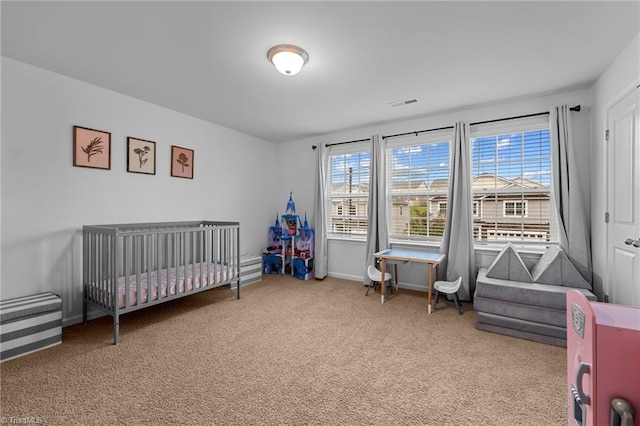 bedroom featuring carpet and a crib