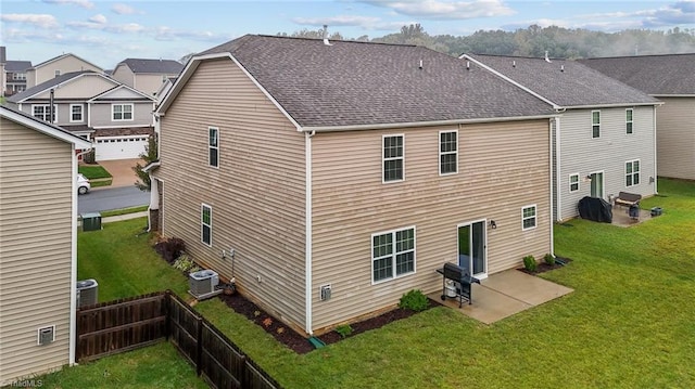 back of property featuring a lawn, cooling unit, a patio area, and a garage