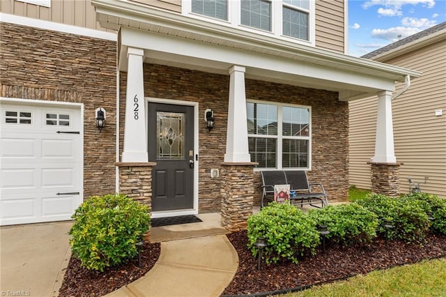 doorway to property featuring a porch and a garage