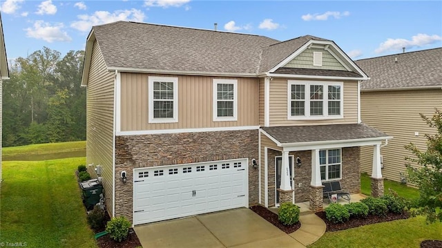 craftsman-style home with a garage and a front lawn