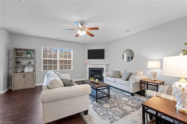 living room featuring dark hardwood / wood-style floors and ceiling fan