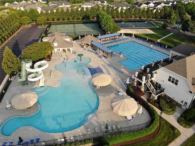 view of swimming pool featuring a water slide and a patio area