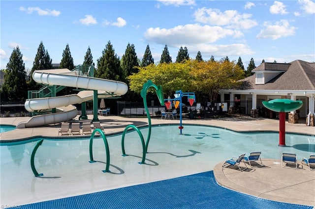 view of swimming pool with a patio and a water slide